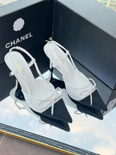 Chanel Metallic Silver Slingback Heels with Black Cap Toe & Bow – Modern Designer Elegance