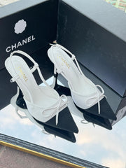 Chanel Metallic Silver Slingback Heels with Black Cap Toe & Bow – Modern Designer Elegance