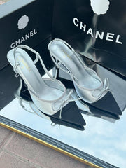 Chanel Metallic Silver Slingback Heels with Black Cap Toe & Bow – Modern Designer Elegance